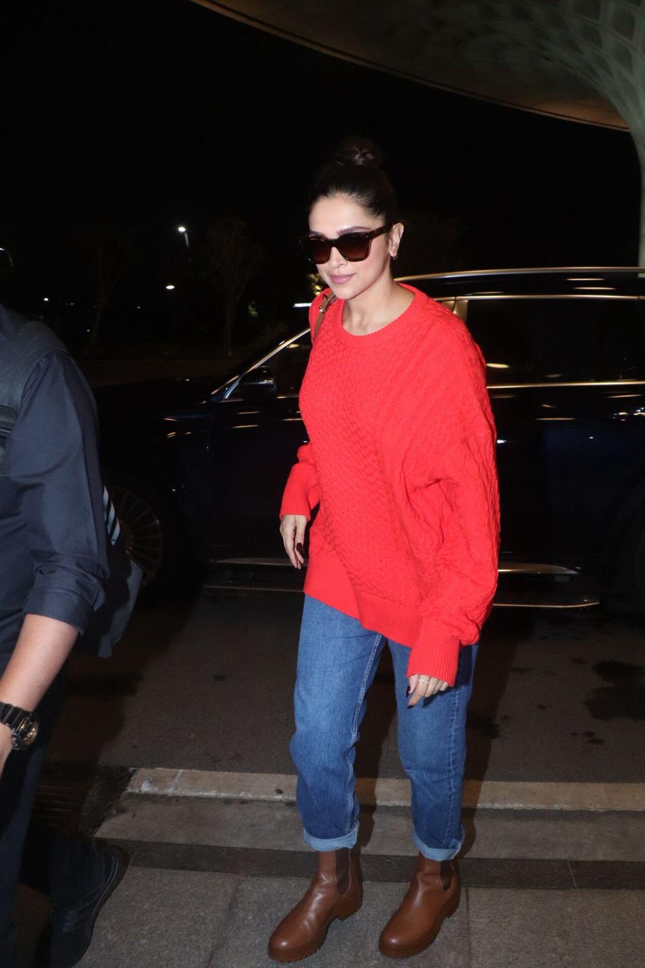 <p>Deepika Padukone was all smiles as she poses for paparazzi before flying out of Mumbai for Louis Vuitton event.For the travel, she wore a red sweater, denims and brown boots.&nbsp;</p>